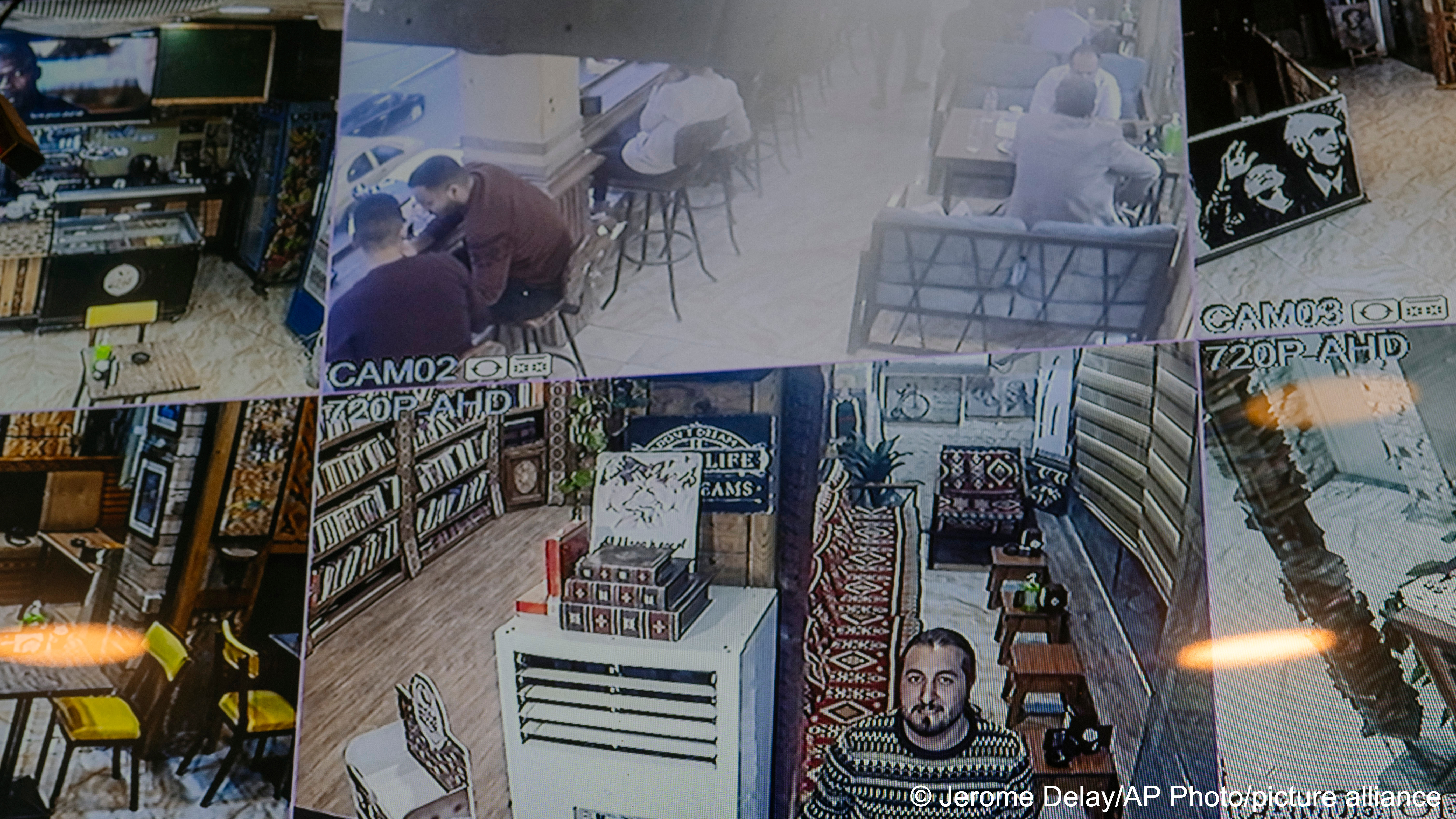 Safaa Rashid looks into a security camera in a Baghdad cafe, Monday, Feb.  27, 2023. The 26-year-old was a child when the Americans arrived in 2003,  but he said he rues “the loss of a state, a country that had law and  establishment” (image: AP Photo/Jerome Delay)