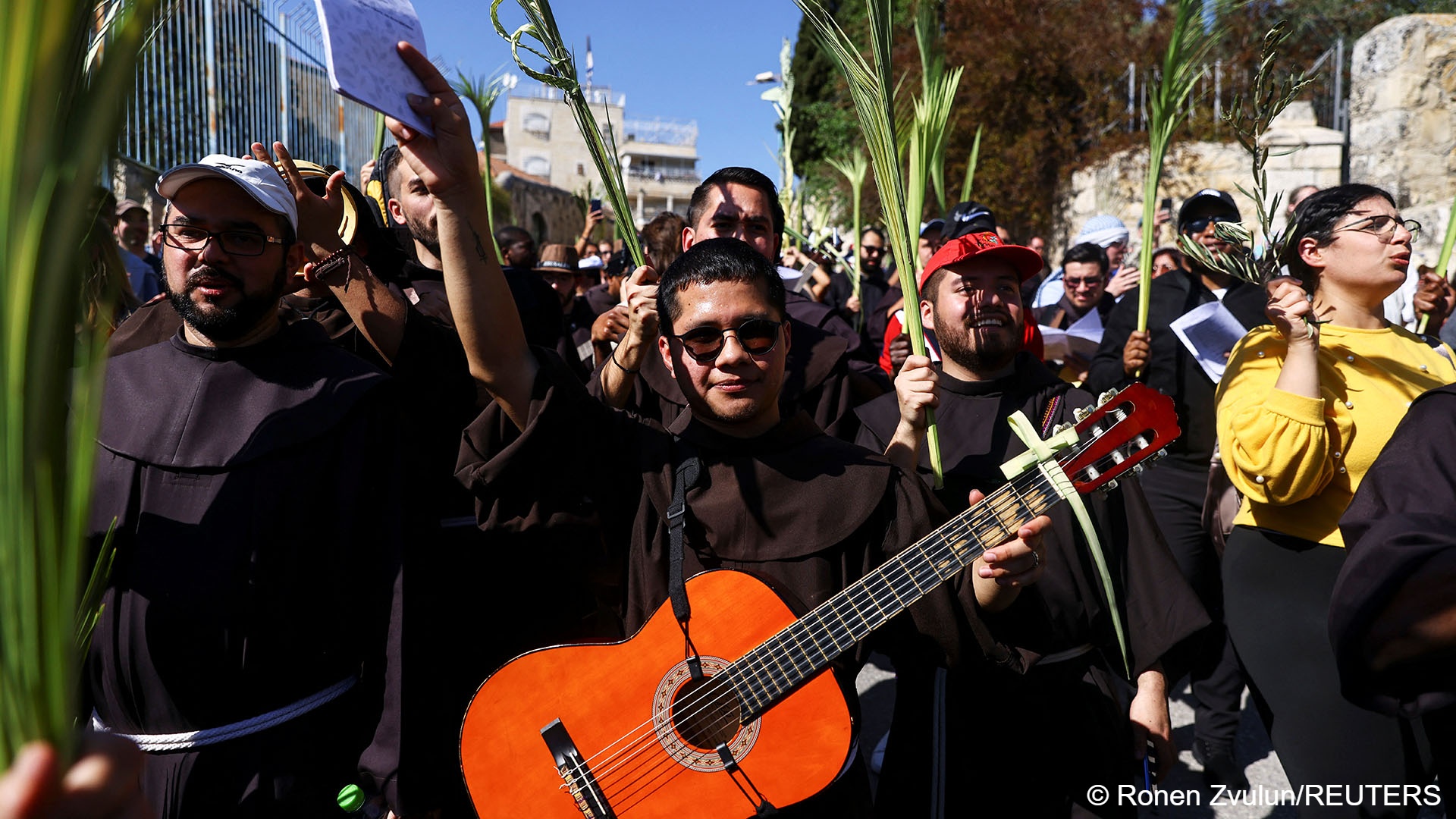 Christian worshippers play instruments as they attend a Palm Sunday procession on the Mount of Olives in Jerusalem, 2 April 2023 (image: REUTERS/Ronen Zvulun)