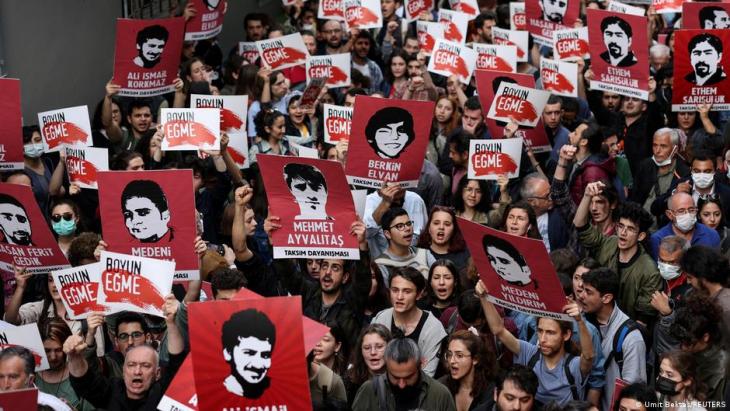 People hold up placards during a protest against the sentencing of Osman Kavala, Istanbul, Turkey, 26 April 2022 (photo: Umit Bektas/Reuters)