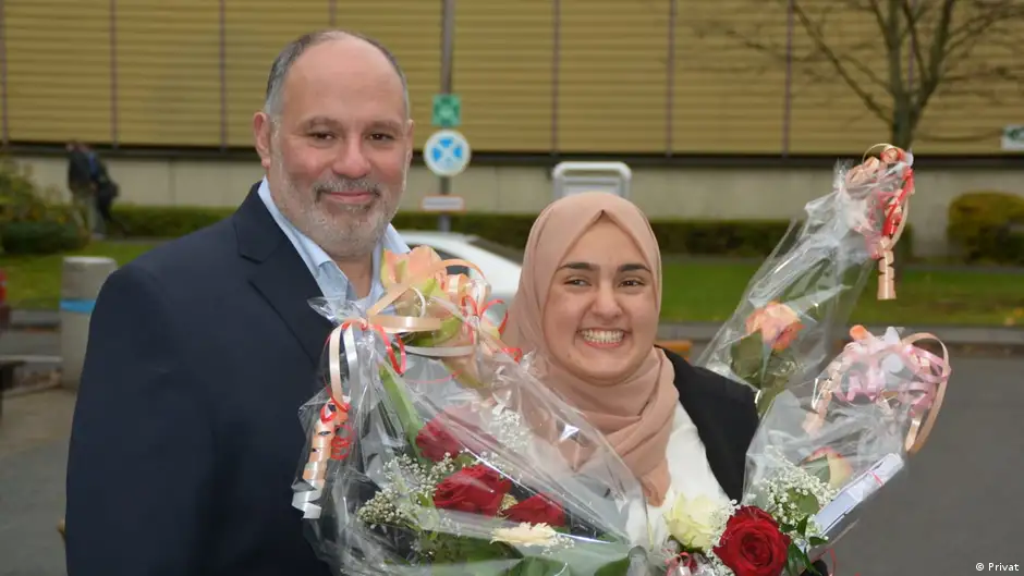Fagr Eladly, holding bouquets of flowers, and her father Alaa Eladly in Wiesbaden, Germany (image: private)
