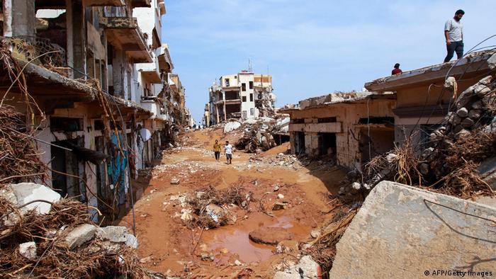 People check an area damaged by flash floods in Derna, eastern Libya