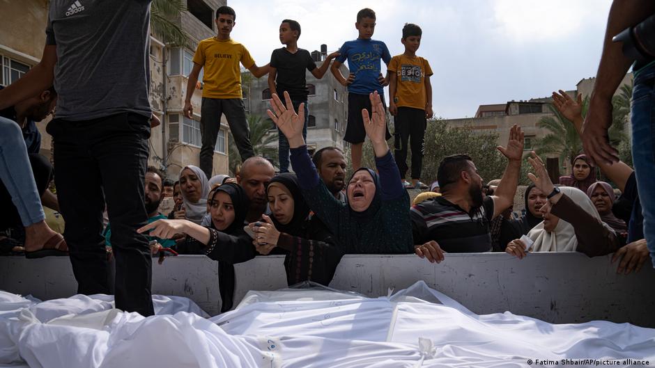 Relatives mourn people killed in an Israeli air strike in Gaza City