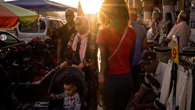 A family walks through a market