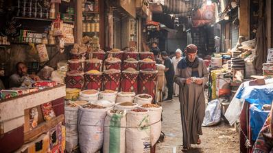 A man walks in the narrow streets of the spice market. 