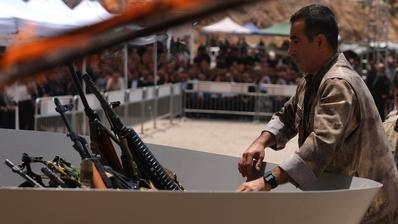 رجل يلقي أسلحة في النار. (Foto: Picture Alliance/Anadolu | Stringer)
