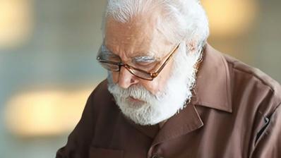 A man with a white beard and glasses.