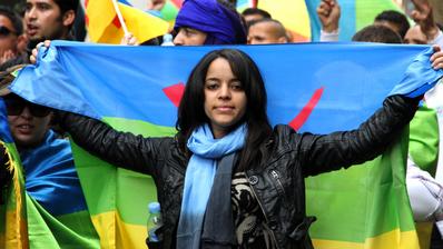 In this April 22, 2012, photo, an activist carries the Berber flag during a march calling for greater rights and autonomy in the Moroccan city of Casablanca, April 2012.