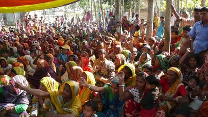 Large group of women in Bangladeshi attire gathered together outside