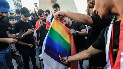 Supporters of the Popular Mobilisation Forces burn a rainbow flag during a protest in Tahrir Square in Baghdad Supporters of the Popular Mobilisation Forces burn a rainbow flag during a protest in Tahrir Square in Baghdad