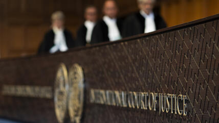 Judges enter the hall of the International Court of Justice