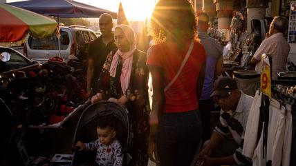 A family walks through a market