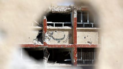 The word “freedom” written on a demolished house