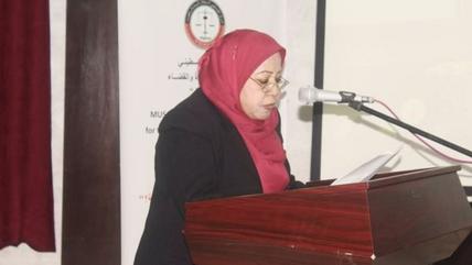 A woman speaks at a podium