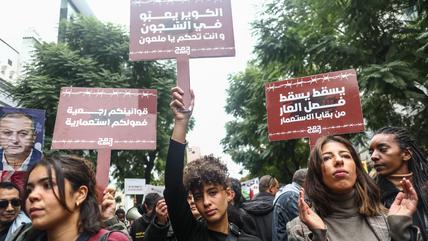 A group of female demonstrators holding signs.