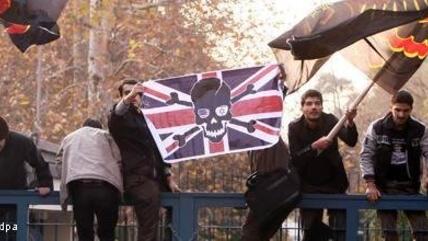 Members of the Basij militia waving anti-British flags as they storm the British embassy in Tehran (photo: dapd)