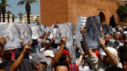 Anti-government protesters shout as they hold a poster of Kamal Al-Amri, pictured, a member of Morocco's main opposition Islamist group who died in June from wounds sustained during a pro-reform demonstration several days earlier, during a rally organized by the 20th February movement in Rabat, Morocco, Sunday June 5, 2011 (photo: AP/Abdeljalil Bounhar)
