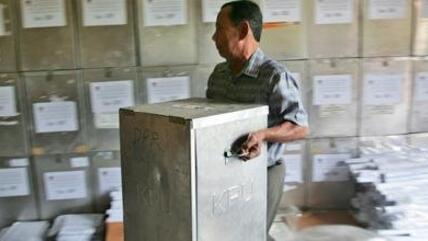 Man carrying a ballot box in Indonesia