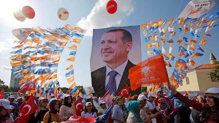 Supporters of Turkey's Prime Minister Recep Tayyip Erdogan watch a rally organised by the ruling Justice and Development Party in Ankara, 15 June 2013 (Photo: Reuters)