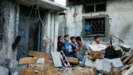 Palestinian boys stand next to the destroyed house of Hejazi family after what Hamas Health Ministry said was an Israeli air strike in the northern Gaza Strip November 20, 2012 (photo: Reuters)