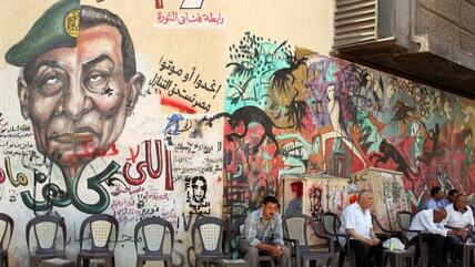 The two faces of the regime: Graffiti on the wall of a café in Cairo showing the faces of Mubarak and Tantawi (photo: Reuters) 
