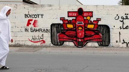 Man passing by anti-Formula One protests mural in Manama, Bahrain (photo: Reuters)