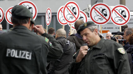 Supporters of the right-wing Pro-NRW movement in Germany demonstrating in Cologne in June 2012 under a heavy police presence (photo: picture-alliance/dpa)
