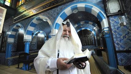 Israeli Rabbi Maimoun, 67, from Tel Aviv and born in Tunis, reads the Torah in the Ghriba Synagogue on April 29, 2010 on the eve of the Jewish annual pilgrimage in Djerba (photo: Fethi Belaid/AFP/Getty Images)