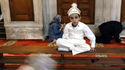 A Turkish boy in traditional circumcision costumes at a mosque in Istanbul (photo: AP)