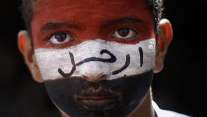 Face of a Yemeni youth his face painted in the colours of the Yemeni flag (photo: AP)