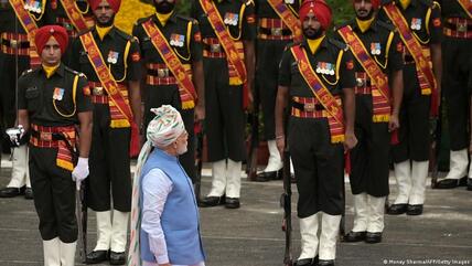 India's Prime Minister Narendra Modi (C) inspects a guard of honour before addressing the nation from the ramparts of the Red Fort during the celebrations to mark countrys Independence Day in New Delhi on 15 August 2022.