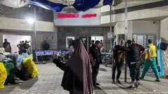 People stand outside the emergency ward at Al-Shifa Hospital, Gaza City