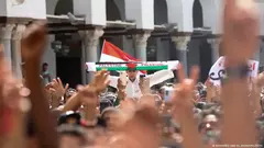 A Palestinian scarf is held aloft amid a sea of hands during a pro-Palestinian demonstration in Egypt