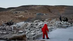 Person in a red hoodie in front of a destroyed house – The documentary film "No Other Land" was shot by a Palestinian-Israeli collective