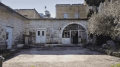 Exterior view of Qusay Awad's family home, built of stone with a courtyard