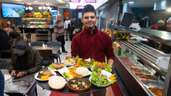 نادل يحمل صحن سفرة فيه أطباق مأكولات سورية في مطعم بإسطنبول - تركيا. 