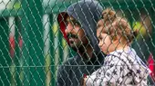 Germany: Mecklenburg-Western Pomerania. Refugees (asylum seeker and child) in front of migrant reception centre