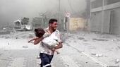 Man carries injured child in Gaza following Israeli airstrike
