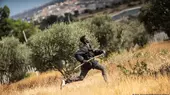 A migrant runs across a field in the Spanish enclave of Melilla