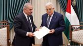 Palestinian Prime Minister Mohammad Shtayyeh (left) submits the resignation of his government to President Mahmoud Abbas in the West Bank city of Ramallah