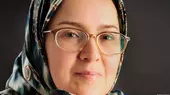 Headshot of a women (Sedigheh Vasmaghi) wearing glasses and a headscarf
