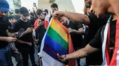  Supporters of the Popular Mobilisation Forces burn a rainbow flag during a protest in Tahrir Square in Baghdad