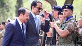 Cyprus President Nikos Christodoulides (left) with Qatar's Emir Sheikh Tamim bin Hamad al-Thani review a military guard on the way to a meeting in the Cypriot presidential palace on 28 May 2024