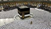 People pray in the Great Mosque and bow towards the Kaaba 