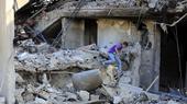 A boy inspects the damage to a building after an Israeli attack in the Lebanese village of Akbieh.