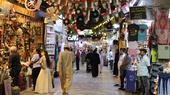 People walking through an indoor market.