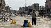 Ein Mann mit Benzinkanistern in einer Straße im Gazastreifen (picture alliance / Zumapress | D. El-Baz Apaimages)