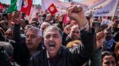 Participants in a protest waved the Tunisian flag and raised banners demanding union rights, social and economic rights, and social dialogue in the country.