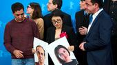 Director Shahrbanoo Sadat, centre with flower, poses with the cast and crew for photographers at the photo call for the film 'No Good Men' during the International Film Festival, Berlinale, in Berlin, Thursday, Feb. 12, 2026.