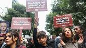 A group of female demonstrators holding signs.