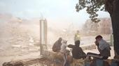 Young men watch the demolition of home. (Photo: Yassine Toumi)